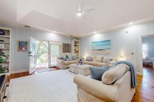 a living room with two couches and a table at Natural Wonder in Edisto Island