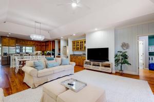 a large living room with a couch and a tv at Natural Wonder in Edisto Island