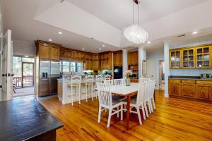 a kitchen with a table and white chairs in it at Natural Wonder in Edisto Island