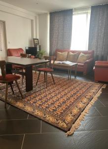 a living room with a couch and a table at Hannover Central Apartment in Hannover