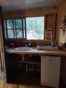 a kitchen with a sink and a window at Shepherds Cabin in Kadita - בקתת רועה בקדיתא in Kadita