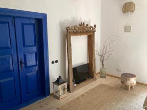 a room with a blue door and a mirror at Good Chata Leśna Polana in Dobry Las