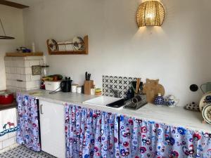 a kitchen with a counter top with a sink at Good Chata Leśna Polana in Dobry Las +10 photos