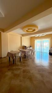 a large room with tables and chairs in it at Vila Papa in Durrës