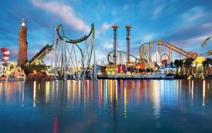 a roller coaster on the water at a carnival at Apartamento a 3 min de la playa, 10 min PortAventura World - Casa Márquez TAC - Costa Dorada in Salou