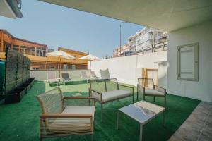 a patio with chairs and tables on a roof at Le Pepite Collection in Giardini Naxos