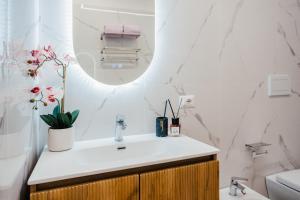 a bathroom with a sink and a mirror at Le Pepite Collection in Giardini Naxos +13 photos