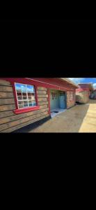 a house with a window on the side of it at Petalluxe k24 in Narok