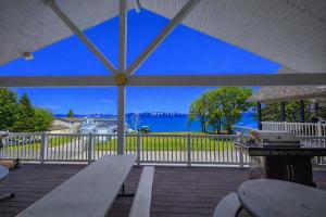 a picnic table on a deck with a view of the water at The Beach House I in Garden City