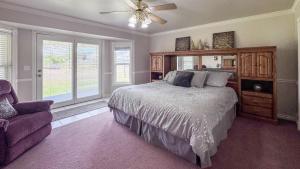 a bedroom with a bed and a ceiling fan at The Beach House I in Garden City