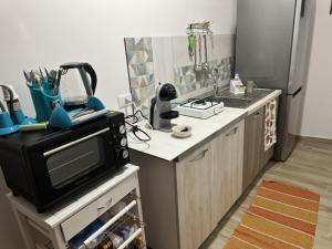 a small kitchen with a microwave and a counter top at Elico Di Sicilia home B in Sambuca di Sicilia +5 photos