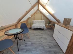 a room with a table and chairs in a tent at Namiot glampingowy u Kasi in Pojezierze