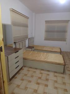a bedroom with two beds in a room at بيت مفروش للايجار-عجلون-اشتفينا in Ajloun