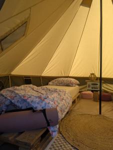 a bedroom with two beds in a tent at Tippihostel Surfschule Kite Passion in Fehmarn