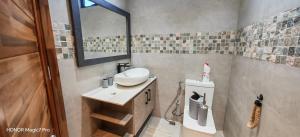 a bathroom with a sink and a mirror at RM Westside Apartment in Case Noyale +3 photos