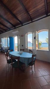 a dining room with a blue table and chairs at Casa delle Galee in Scilla +24 photos