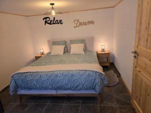 a bedroom with a bed with a sign on the wall at Le Repos du Jorat in Saint-Maurice