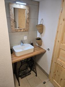 a bathroom with a sink and a mirror at Le Repos du Jorat in Saint-Maurice +6 photos