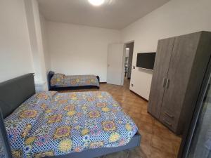 a bedroom with a bed and a cabinet at pomelia holiday house in Riposto