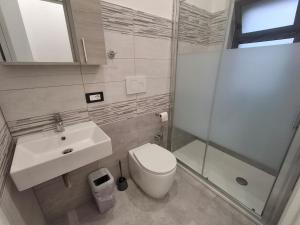a bathroom with a toilet and a sink and a shower at pomelia holiday house in Riposto