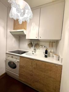 a small kitchen with a sink and a stove at Maison Moena Dolomites in Moena +24 photos
