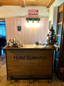 a hotel eulenburg counter with a christmas tree on it at Hotel Eulenhof in Gransdorf