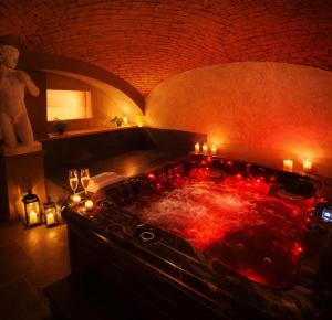 a hot tub in a room with candles in it at Rezidence U Kapličky - stylové ubytování & privátní wellness - Adults Only in Uničov