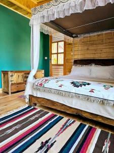 a bedroom with a canopy bed and a rug at Hidden Valley Backpackers in Iringa