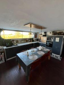 a kitchen with a table with chairs and a kitchen with a stove at Péniche Bonne Chance in Eckwersheim +12 photos