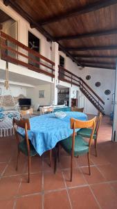 a dining room with a blue table and chairs at Casa delle Galee in Scilla