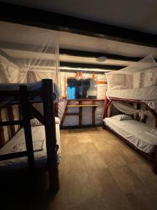 a room with two bunk beds and a table at HIDDEN HOSTAL MONTANITa in Montañita