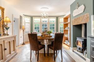 a dining room with a table and chairs and a fireplace at 5 Bed in Belper oc-b29775 in Belper