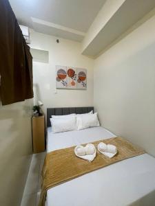 a bedroom with two heart shaped towels on a bed at Casa Lumière in Tagaytay +29 photos