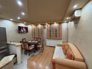 a living room with a table and a dining room at Sunset Apartman Obrenovac,Centar in Obrenovac