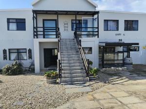 a white house with stairs in front of it at Intimi2 in Yzerfontein