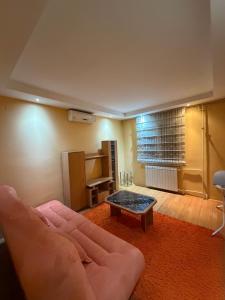 a living room with a couch and a coffee table at Sunset Apartman Obrenovac,Centar in Obrenovac