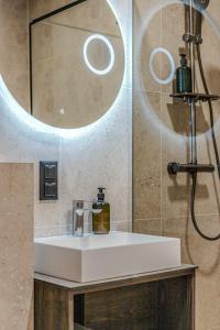 a bathroom with a white sink and a mirror at Topolių terasos in Palanga +52 photos