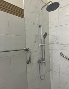 a shower with a glass door in a bathroom at Haven Garden Retreat in Kingston