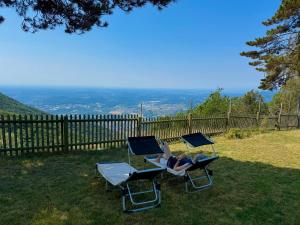 two chairs and a table with a laptop on it at Panoramic views on Monte Generoso, peace & nature in Castel San Pietro +34 photos