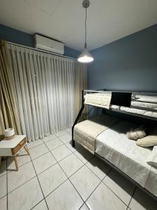 a bedroom with two bunk beds and a table at Apartment 1 Peniel in Copán Ruinas