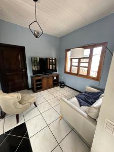 a living room with a couch and a tv at Apartment 1 Peniel in Copán Ruinas