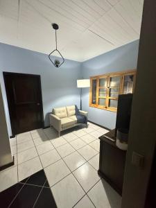 a living room with a couch and a tv at Apartment 1 Peniel in Copán Ruinas