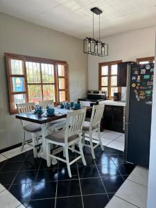 a kitchen with a table and chairs and a refrigerator at Apartment 1 Peniel in Copán Ruinas