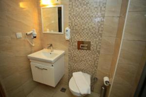 a bathroom with a toilet and a sink and a shower at The Marmaris Boutique Hotel in Marmaris