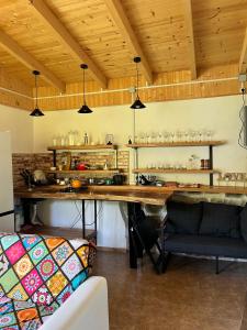 a kitchen with a large wooden table in a room at Marisi Cottage - კოტეჯი მარისი in Ambrolauri