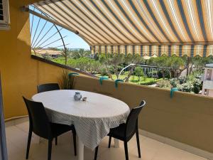 a table and chairs on a balcony with a large window at Blu 31 Marcelli in Marcelli