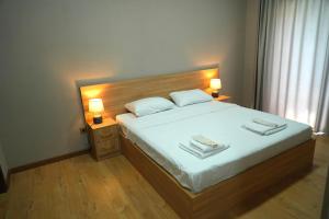 a bedroom with a bed with two towels on it at Hotel Kvarlis Mtebi in Kvareli +25 photos
