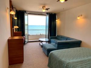 a bedroom with a bed and a couch and a table at Palace Resort in Venus