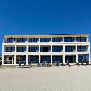 a large white building with chairs in front of it at Palace Resort in Venus