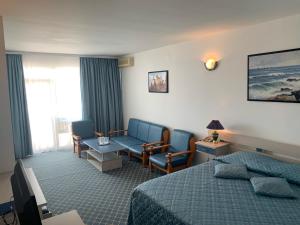 a hotel room with a bed and a couch at Palace Resort in Venus